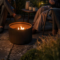 A pellet fire pit burning at dusk
