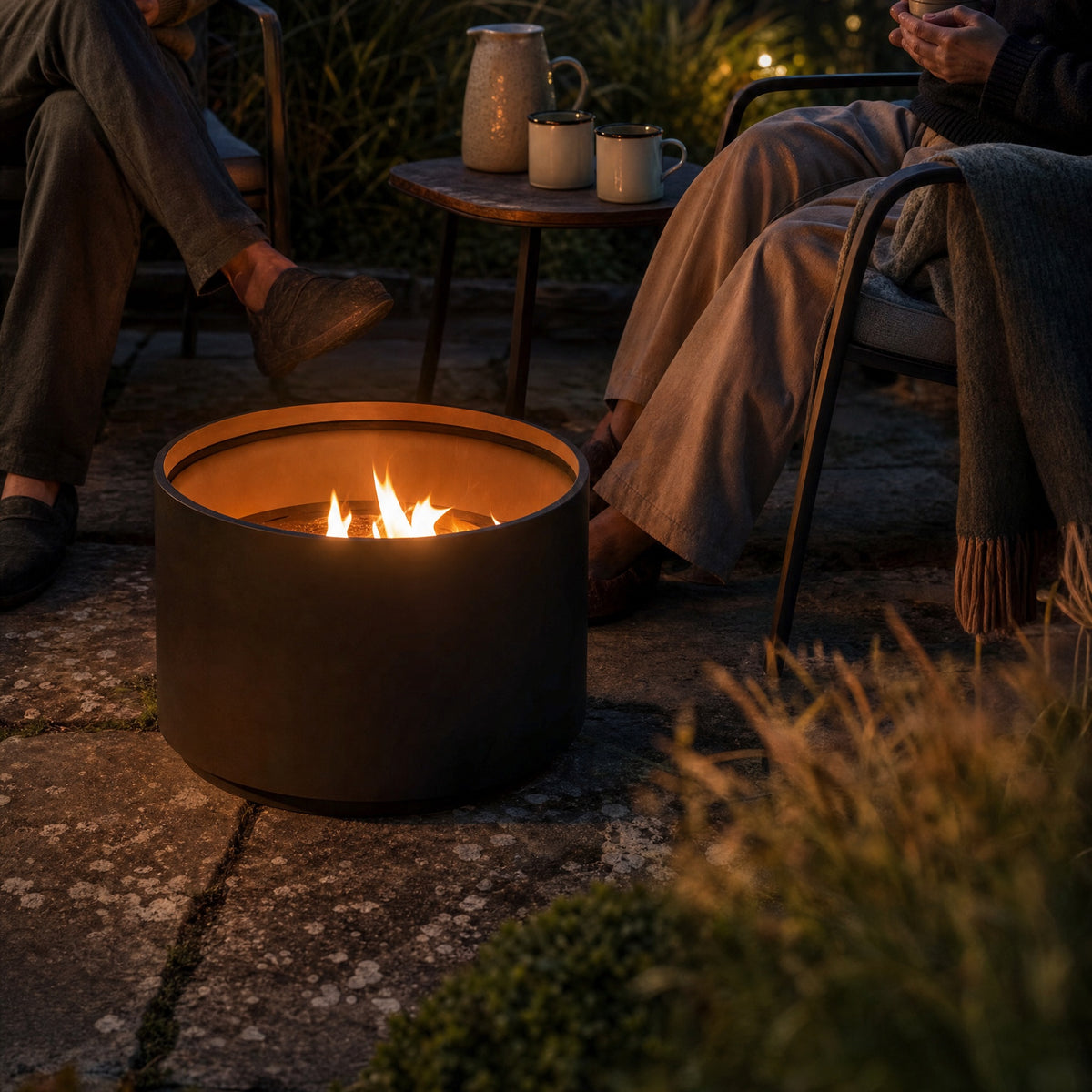 A pellet fire pit burning at dusk