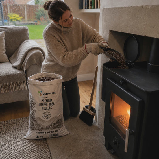 Loading COFFUEL coffee husk pellets into a pellet stove